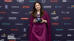 Rachel holding an award 